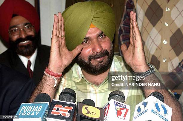 Former Indian cricketer and current Bharatiya Janata Party Member of Parliament Navjot Singh Sidhu gestures as he addresses media representatives at...