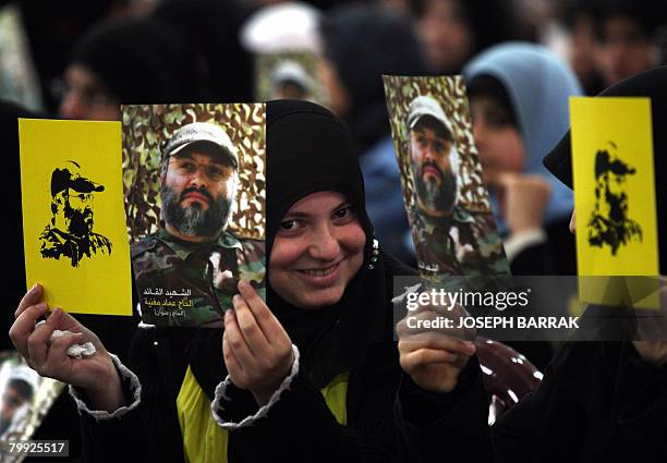 Lebanese Shiite Muslim women hold-up images of assassinated top Hezbollah commander Imad Mughnieh, as they gather to watch a televised speech by...