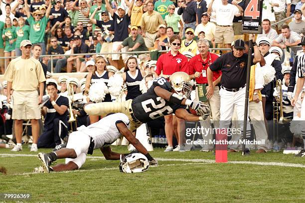 Notre Dame runningback Travis Thomas dives for the corner of the endzone and scores a touchdown against Penn State at Notre Dame Stadium in South...