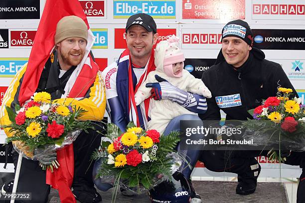 Jon Montgomery of Canada, Kristan Bromley of Great Britain and German?s Frank Rommel celebrate their success after the Men?s Skeleton World...