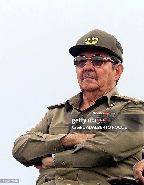 The Cuban Minister of armed forces Raul Castro observes the honor that was given to seven guerillas; three Cubans, three Bolivians and one Peruvian,...