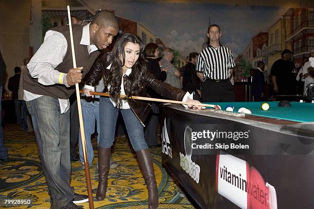 Player Reggie Bush of the New Orleans Saints helps Kim Kardashian with her pool shots at the 2008 NBA All-Star Shaquille O'Neal and Reggie Bush...