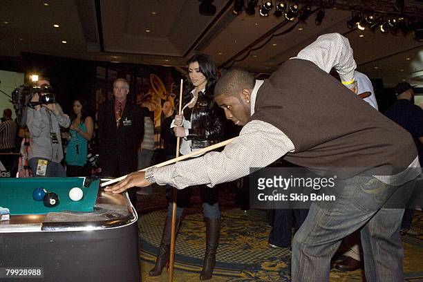 Player Reggie Bush of the New Orleans Saints helps Kim Kardashian with her pool shots at the 2008 NBA All-Star Shaquille O'Neal and Reggie Bush...