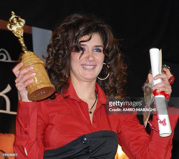 Egyptian film star Ghada Adel wins the best actress award at the 56th Catholic Centre film festival in Cairo on February 22, 2008 for her role in...