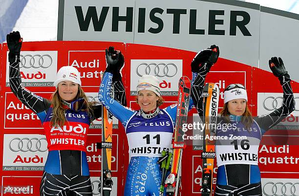 Nadia Styger of Switzerland celebrates her first place victory beside second place finisher Lindsey Vonn of the USA and third place finisher Julie...