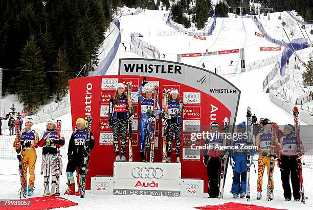 Nadia Styger of Switzerland celebrates her first place victory beside second place finisher Lindsey Vonn of the USA and third place finisher Julie...