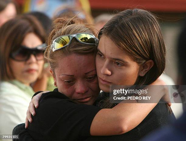 Family members of the victims of Santa Barbara Airlines flight 518, which crashed in the Venezuelan Andes on Thursday, try to console each other at...