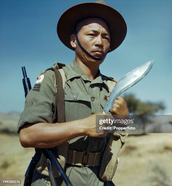 Portrait of Havildar Kulbahadur Gurung, of a Gurkha regiment of the 23rd Indian Infantry Division of the British Army, World War II, holding his...