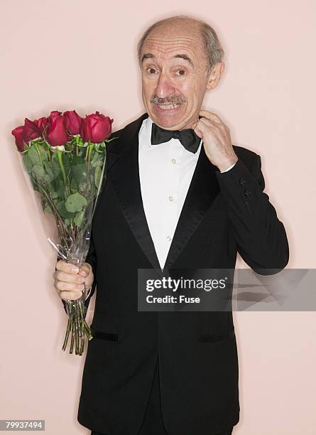 nervous man in tuxedo with bouquet of roses - un certain regard stock pictures, royalty-free photos & images