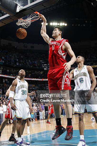 Yao Ming of the Houston Rockets dunks on David West and Tyson Chandler of the New Orleans Hornets at the New Orleans Arena February 22, 2008 in New...