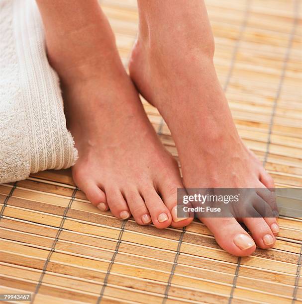 womans bare feet on bamboo mat - bamboo flooring stock pictures, royalty-free photos & images