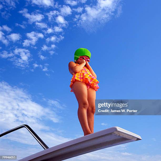 little girl standing on diving board - kids swim caps stock pictures, royalty-free photos & images