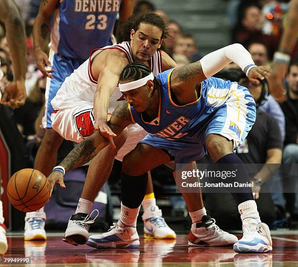 Joakim Noah of the Chicago Bulls battles for a loose ball with Carmelo Anthony of the Denver Nuggets on February 22, 2008 at the United Center in...