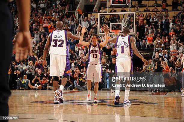 Steve Nash of the Phoenix Suns celebrates a basket with Shaquille O'Neal and Amare Stoudemire in an NBA game played against the Boston Celtics at...