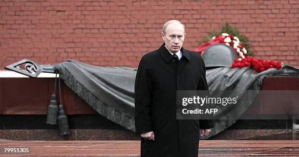 Russian President Vladimir Putin attends a wreath-laying ceremony at the Unkown Soldier's tomb during a national holiday, the Day of the Fatherland's...