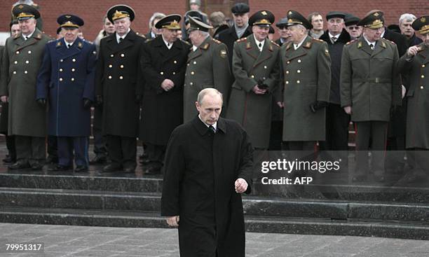 Russian President Vladimir Putin attends a wreath-laying ceremony at the Unkown Soldier's tomb during a national holiday, the Day of the Fatherland's...