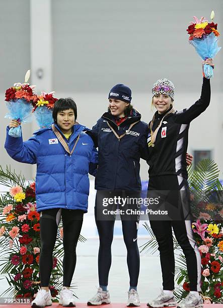 Do-Yeong Park of South Korea, Marrit Leensra of the Netherlands and Nicole Garrido of the Canada pose on the podium with their medals after the...