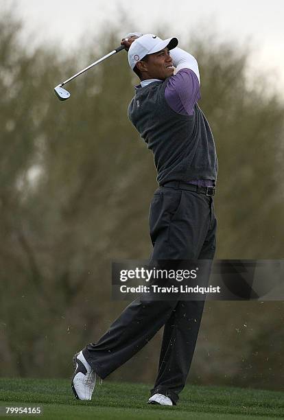 Tiger Woods watches his approach shot on the second hole during the quarterfinal matches of the WGC-Accenture Match Play Championship at The Gallery...