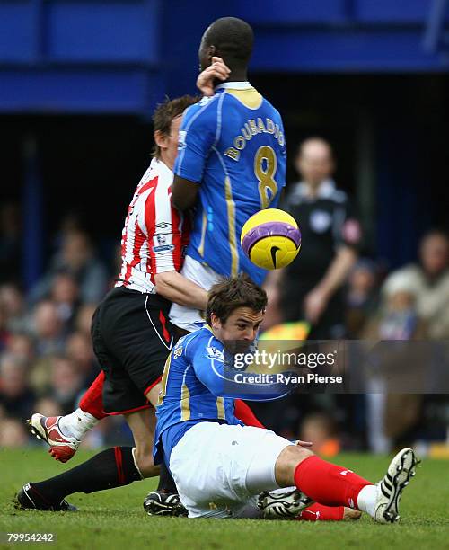 Niko Kranjcar and Papa Bouba Diop of Portsmouth colide with Dean Whitehead of Sunderland during the Barclays Premier League match between Portsmouth...