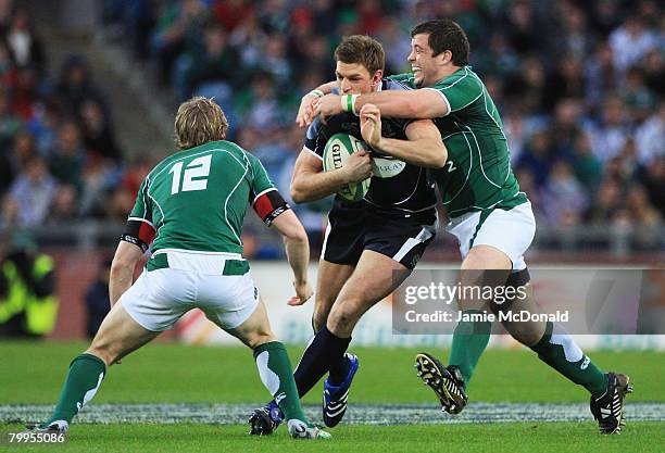 Marcus Horan of Ireland tackles Nikki Walker of Scotland during the RBS 6 Nations Championship match between Ireland and Scotland at Croke Park on...