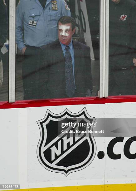 Injured linesman Pat Dapuzzo watches the game between the New York Islanders and the New Jersey Devils at the Prudential Center February 23, 2008 in...