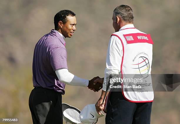 Tiger Woods shakes hands with his caddy Steve Williams after winning the quarterfinal matche of the WGC-Accenture Match Play Championship at The...