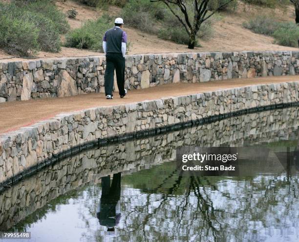 Tiger Woods walks to the fourth fairway during the quarterfinal matches of the WGC-Accenture Match Play Championship at The Gallery at Dove Mountain...