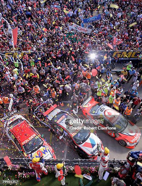 Jamie Whincup 1st place, Cameron McConVille 3rd place and Lee Holdsworth 2nd spray the champagne on the podium after race two of the Clipsal 500...