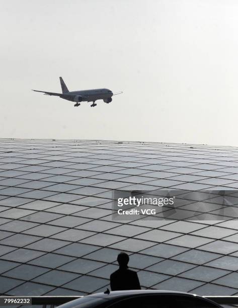 Plane flys overhead during a drill in newly-built No. 3 terminal of Beijing international airport on February 23, 2008 in Beijing, China. The drill...