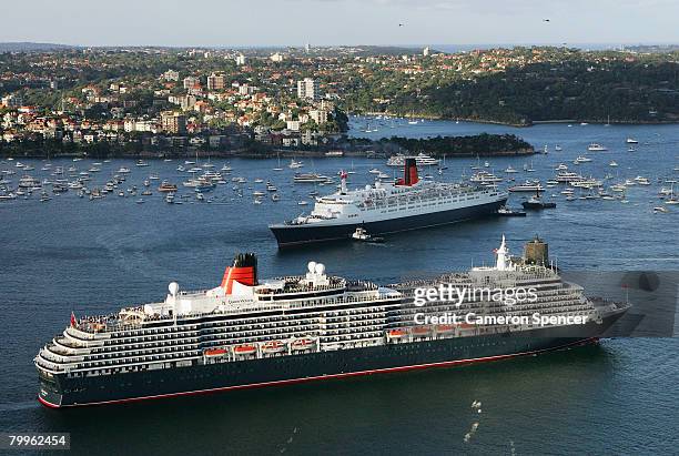 The Queen Elizabeth II ship passes fellow Cunard luxury liner the Queen Victoria at Garden Island in Sydney Harbour on their final and first voyages...