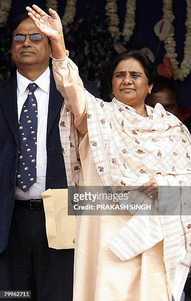 Bahujan Samaj Party President and Chief Minister of the Indian state of Uttar Pradesh Mayawati waves as BSP's National General Secretary Satish Misra...