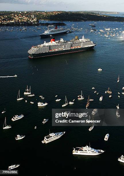 The Queen Elizabeth II ship passes fellow Cunard luxury liner the Queen Victoria at Garden Island in Sydney Harbour on their final and first voyages...