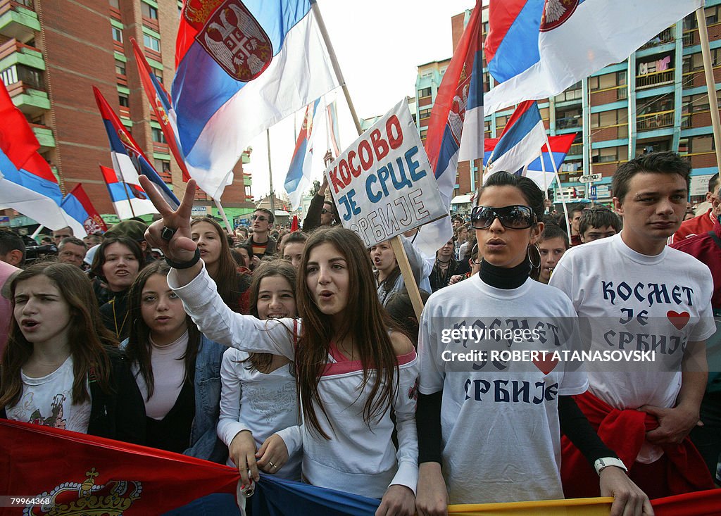 Kosovo Serb youths shout slogans and wav