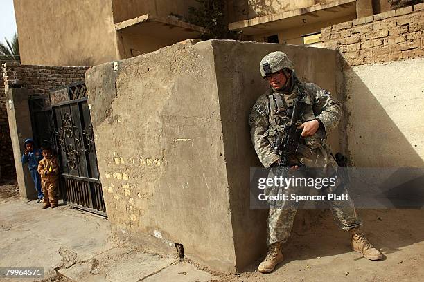 Sgt. Ricky Butler with the U.S. Army 501st M.P. Company 1st Armored Division and of Memphis, Tennessee, participates in a joint patrol with members...