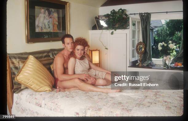 Actress Lisa Akey and husband Raphel Sbarge sits on their bed at home August 18, 1995 in Los Angeles, CA. Akey, the star of the new Aaron Spelling tv...