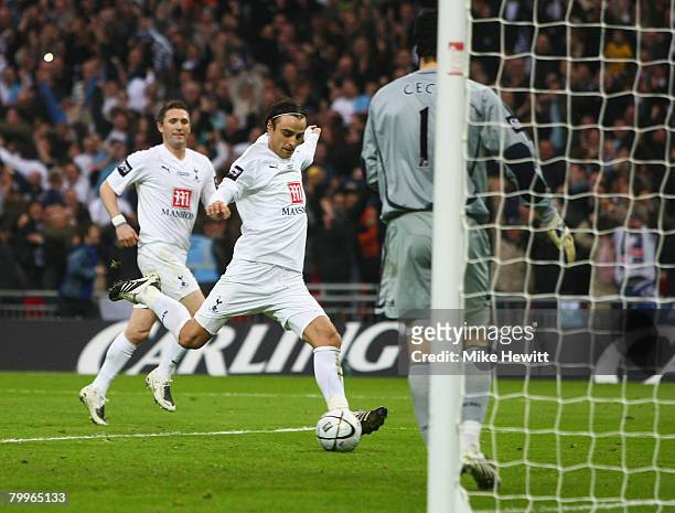 Dimitar Berbatov of Tottenham Hotspur celebrates by kicking the ball into the net as he scores their first goal from the penalty spot during the...