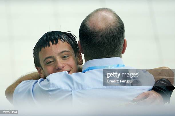 Great Britain's Tom Daley celebrates his high score with his coach during the men's 10m platform final of the "Good Luck Beijing" 2008 16th FINA...