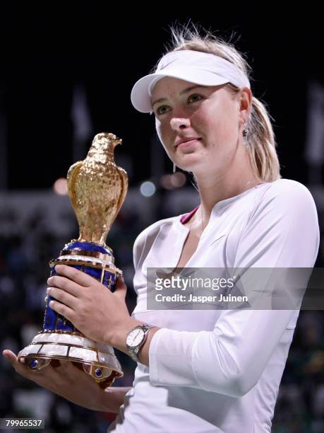 Maria Sharapova of Russia holds up the Golden Falcon award after winning her WTA Qatar Total Open final match against Vera Zvonareva of Russia on day...