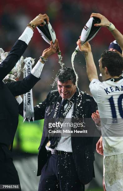 Juande Ramos manager of Tottenham Hotspur has champagne poured over him by Robbie Keane following the Carling Cup Final between Tottenham Hotspur and...