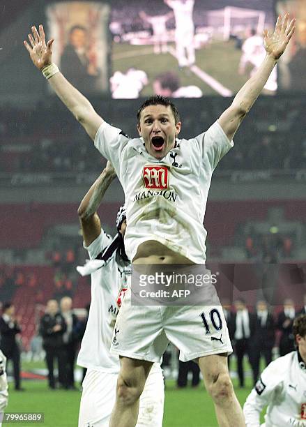 Tottenham Hotspur's Irish striker Robbie Keane celebrates with his teammates after winning the Carling Cup Final match against Chelsea at Wembley...