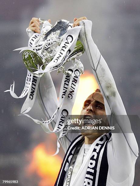 Bulgarian player Dimitar Berbatov celebrates with the trophy after Tottenham Hotspur won the Carling Cup Final against Chelsea at Wembley Stadium in...
