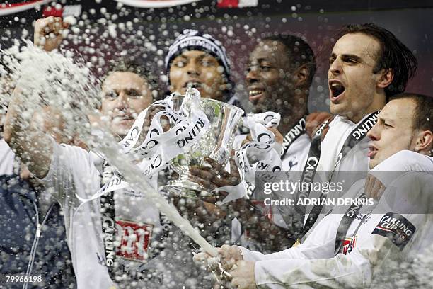 Tottenham Hotspur's Alan Hutton sprays champagne beside his teammates after winning the Carling Cup Final against Chelsea at Wembley Stadium in...