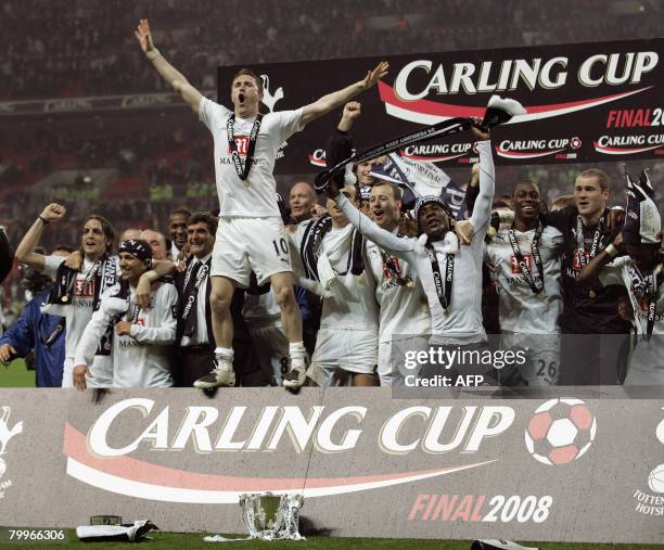 Tottenham Hotspur's Irish striker Robbie Keane celebrates with teammates after winning the Carling Cup Final against Chelsea at Wembley Stadium in...