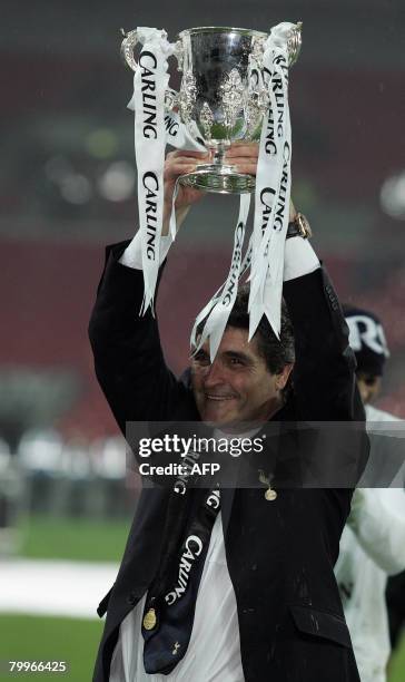 Tottenham Hotspur's Spanish manager Juande Ramos celebrates with the trophy after his team won the Carling Cup Final against Chelsea at Wembley...