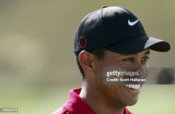 Tiger Woods smiles as he walks across a green during the Championship match of the WGC-Accenture Match Play Championship at The Gallery at Dove...