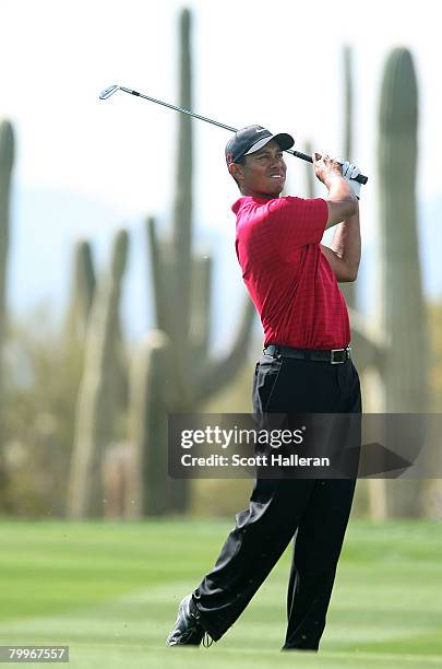 Tiger Woods watches his approach shot on the 27th hole during the Championship match of the WGC-Accenture Match Play Championship at The Gallery at...