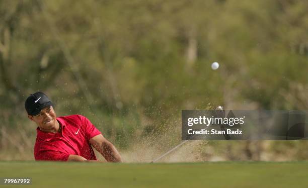 Tiger Woods hits out of the bunker on the seventh hole during the Championship match of the WGC-Accenture Match Play Championship at The Gallery at...