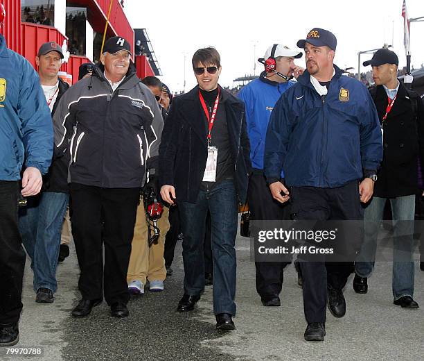 Tom Cruise walks with Team Owner Rick Hendrick during the NASCAR Sprint Cup Series Auto Club 500 at the Auto Club Speedway of Southern California on...