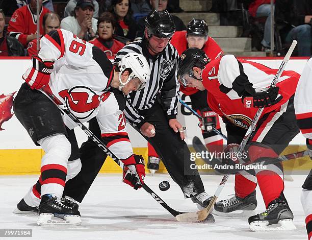 Jason Spezza of the Ottawa Senators faces off against Patrik Elias the New Jersey Devils at Scotiabank Place on February 16, 2008 in Ottawa, Ontario,...