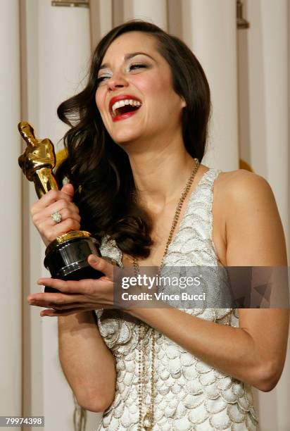 Actress Marion Cotillard, winner of the Performance By An Actress In A Leading Role award for "La Vie en Rose" poses in the press room during the...